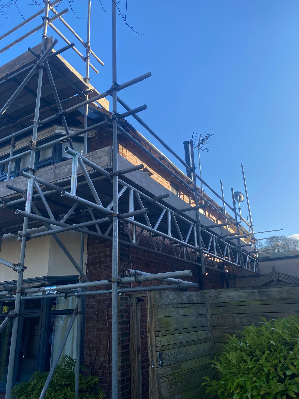Scaffold up and eaves stripped back — the unglamorous preparation stage that makes an exterior finish last.